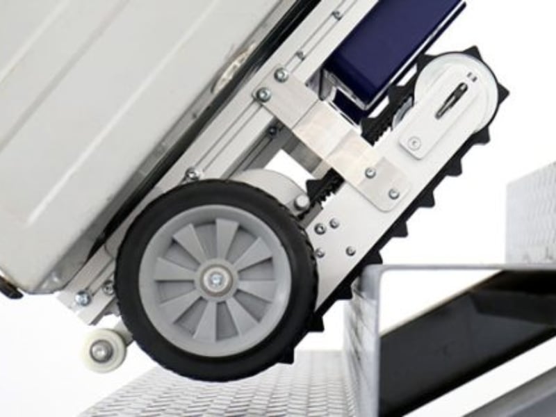 Motorised hand trolley climbing stairs with heavy load using caterpillar tracks and large wheels. 