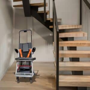 Modern lift for stairs in house installed near wooden staircase for safe accessibility.