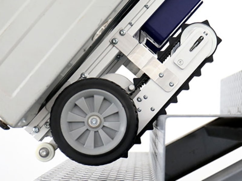 stair trolley hire showing close-up of wheels gripping stairs for safe heavy lifting.