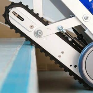 Powered stair climber hire equipment with rubber tracks gripping a stair edge for stability.